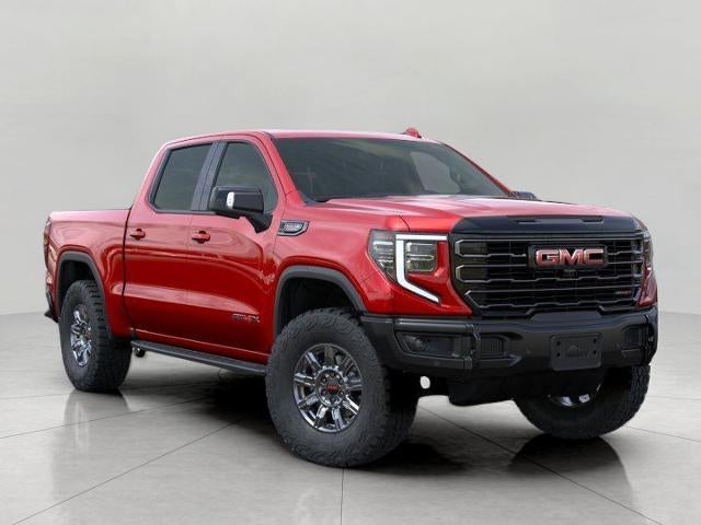 2026 GMC Sierra 1500 4WD Crew Cab 147 AT4X in Volcanic Red Tintcoat — front three-quarter view